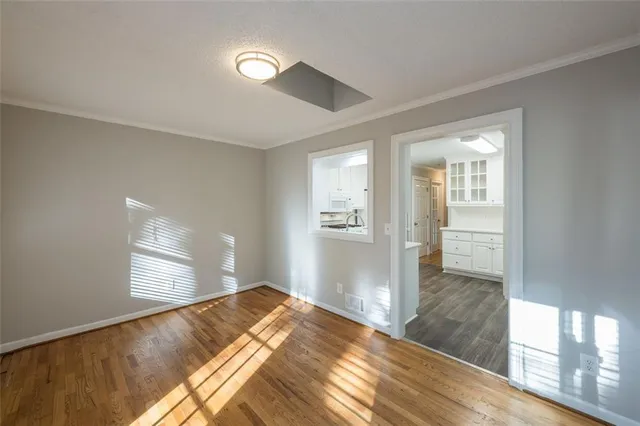 a bed in a spacious bedroom next to a window