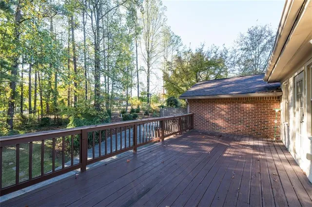 a view of a porch with wooden floor and fence