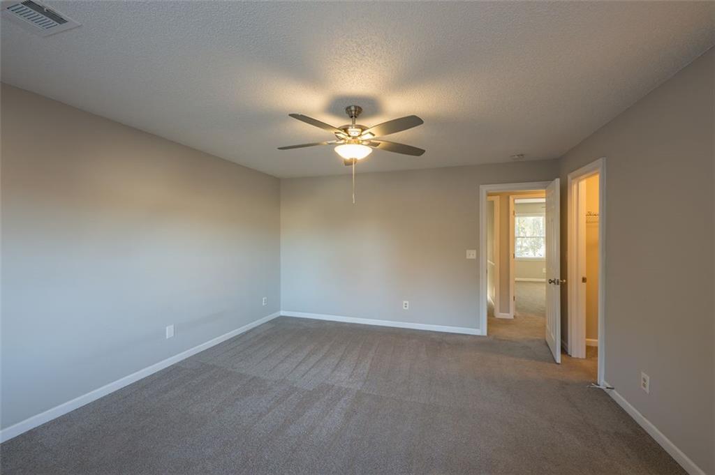 4648 Calumet Circle Northwest Duluth, GA 30096 - Photo 28 of 37 an empty room with closet and ceiling fan