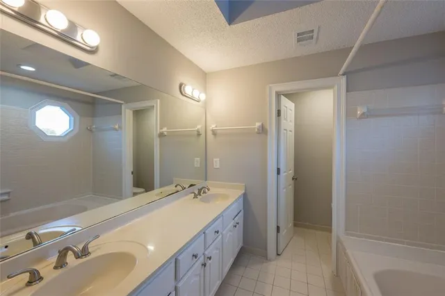 a spacious bathroom with a double vanity sink mirror and double