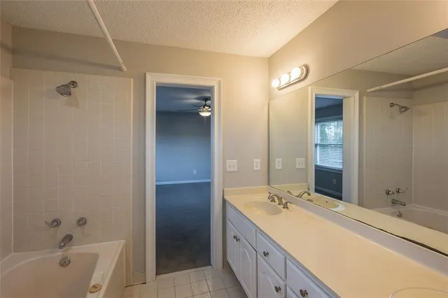 a spacious bathroom with a bathtub sink and mirror