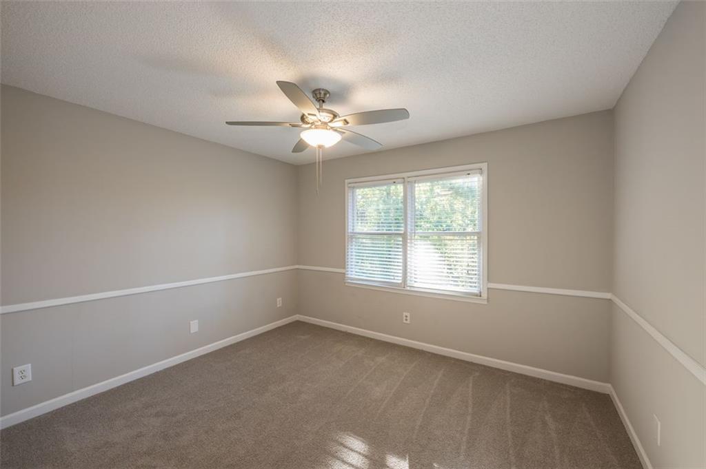 4648 Calumet Circle Northwest Duluth, GA 30096 - Photo 34 of 37 an empty room with a window and a fan