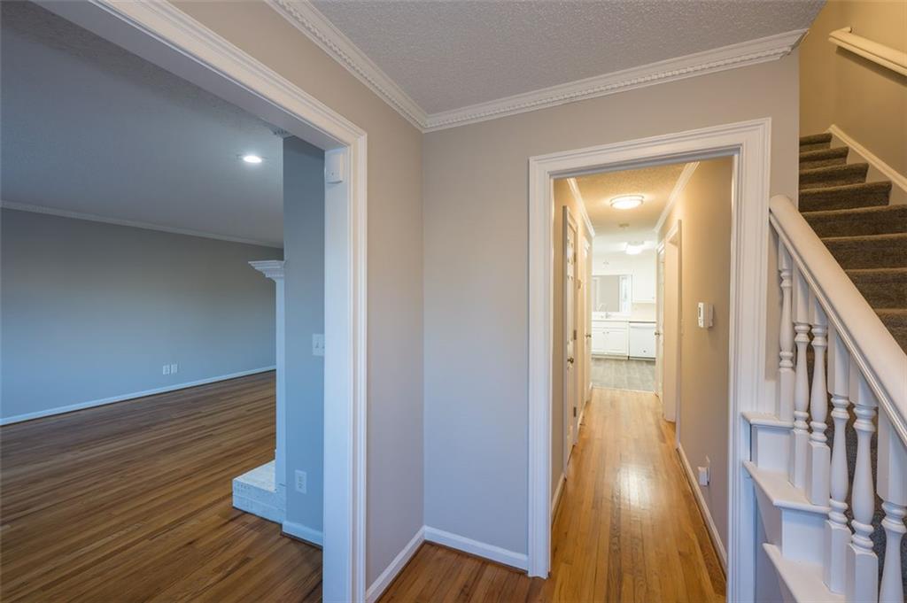 4648 Calumet Circle Northwest Duluth, GA 30096 - Photo 4 of 37 a view of a hallway with wooden floor and staircase