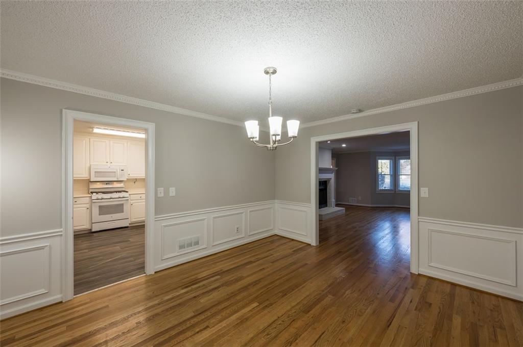4648 Calumet Circle Northwest Duluth, GA 30096 - Photo 10 of 37 wooden floor in an empty room with a window