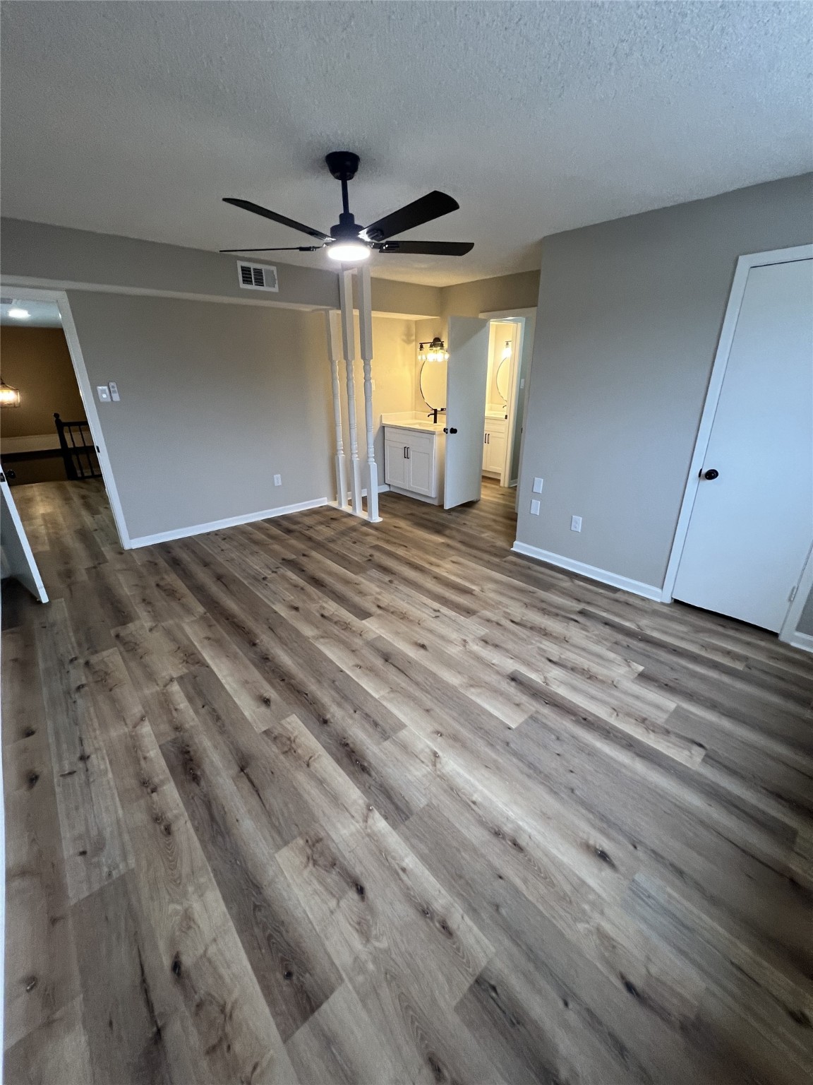 1310 Town Circle, Unit 1 Baytown, TX 77520 - Photo 15 of 21 a view of empty room with wooden floor and fan