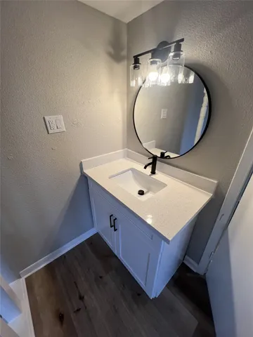 a bathroom with a sink mirror and vanity