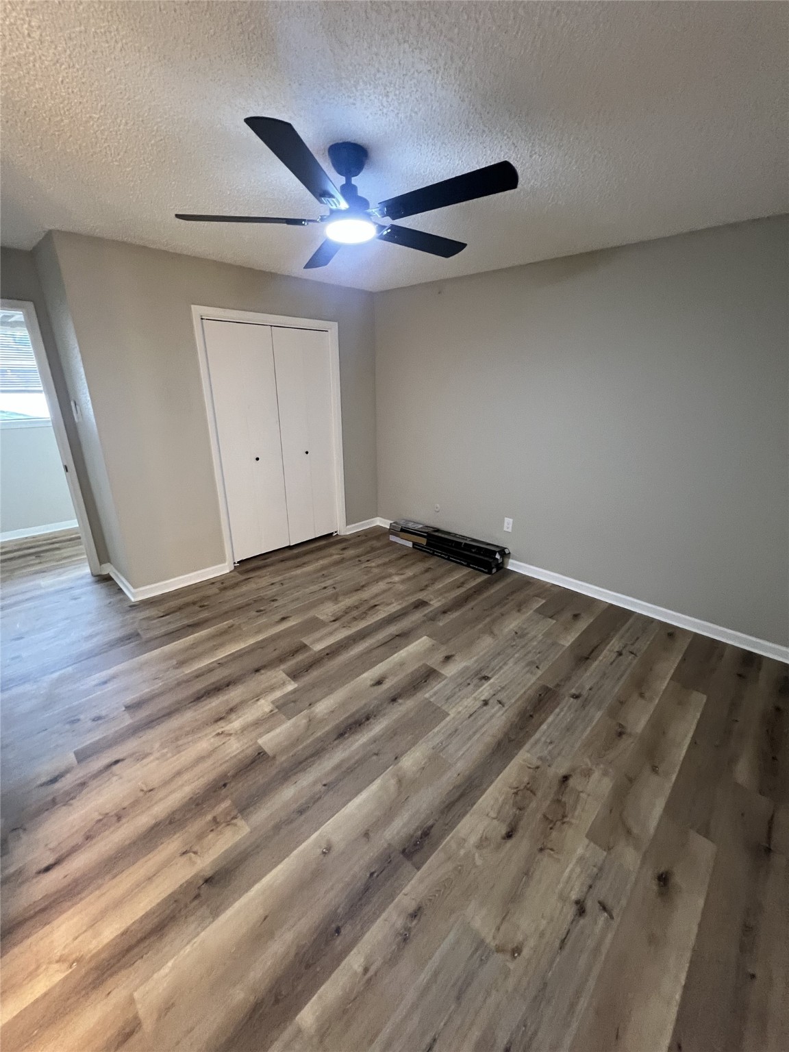 1310 Town Circle, Unit 1 Baytown, TX 77520 - Photo 20 of 21 a view of an empty room with wooden floor and a ceiling fan