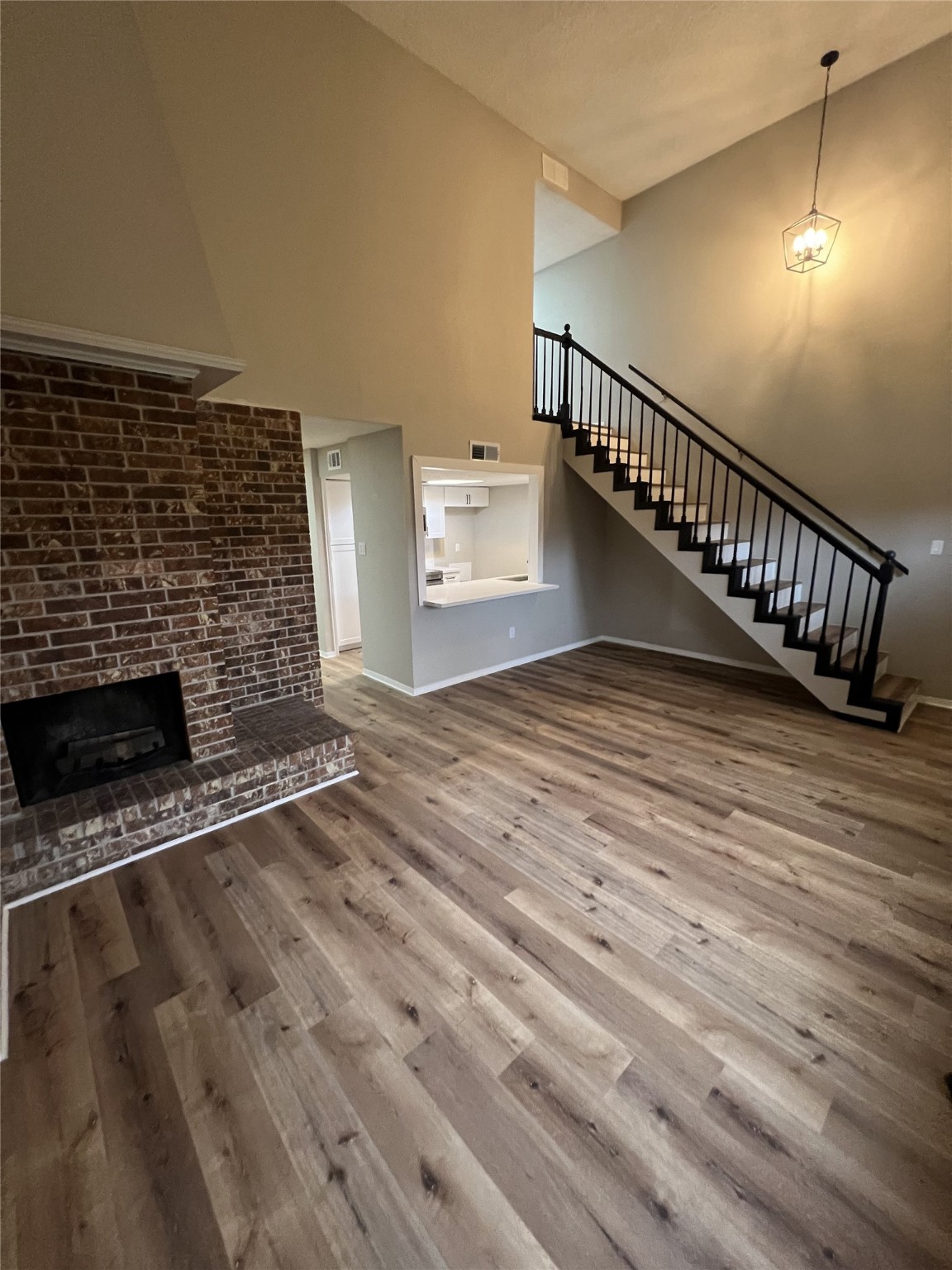 1310 Town Circle, Unit 1 Baytown, TX 77520 - Photo 3 of 21 a view of an empty room with wooden floor and a fireplace