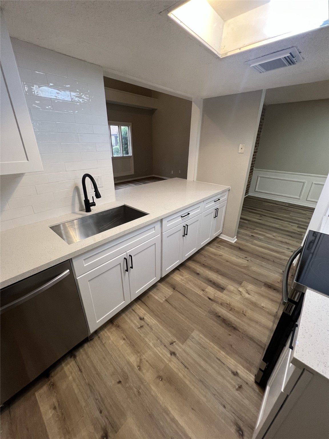 1310 Town Circle, Unit 1 Baytown, TX 77520 - Photo 7 of 21 a kitchen with granite countertop white cabinets and sink