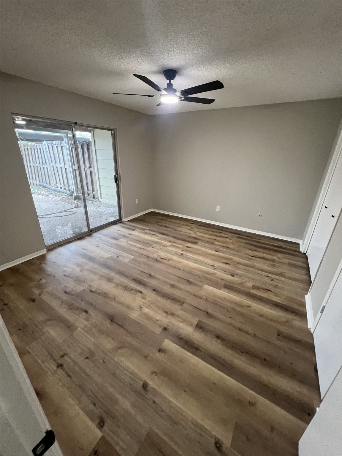 1310 Town Circle, Unit 1 Baytown, TX 77520 - Photo 8 of 21 a view of an empty room with wooden floor and a window