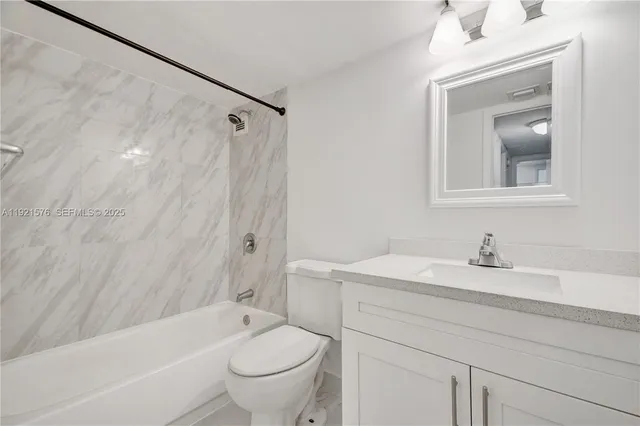 a bathroom with a sink a toilet and a bathtub