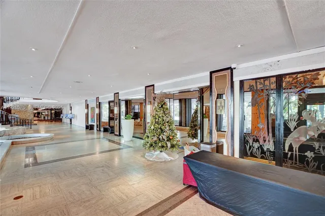 a living room with furniture and large windows