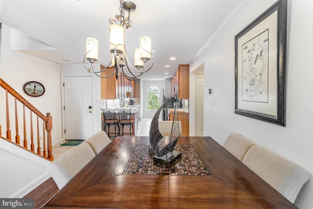 a view of a hallway with dining room and wooden floor