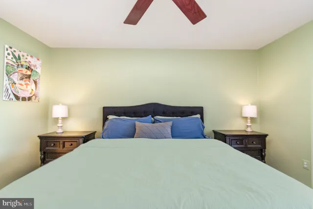 a bedroom with a bed and a night stand