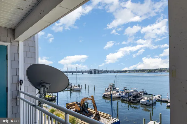 a roof deck with table and chairs