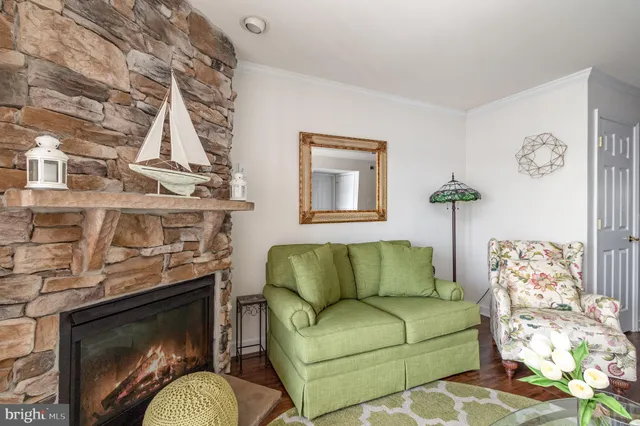 a living room with furniture a fireplace and a table