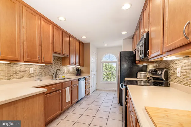 a kitchen with a sink a stove and cabinets