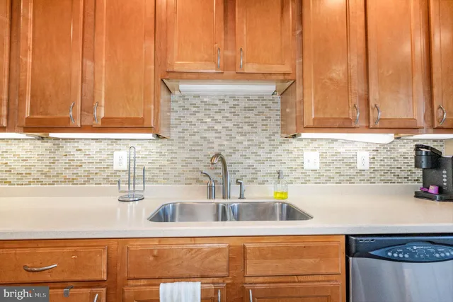 a kitchen with appliances cabinets and a sink