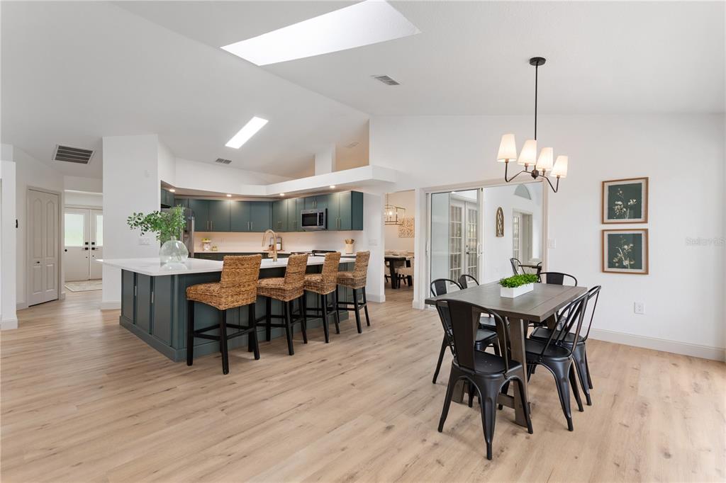 419 Silas Court Spring Hill, FL 34609 - Photo 17 of 56 a view of a dining room with furniture and wooden floor