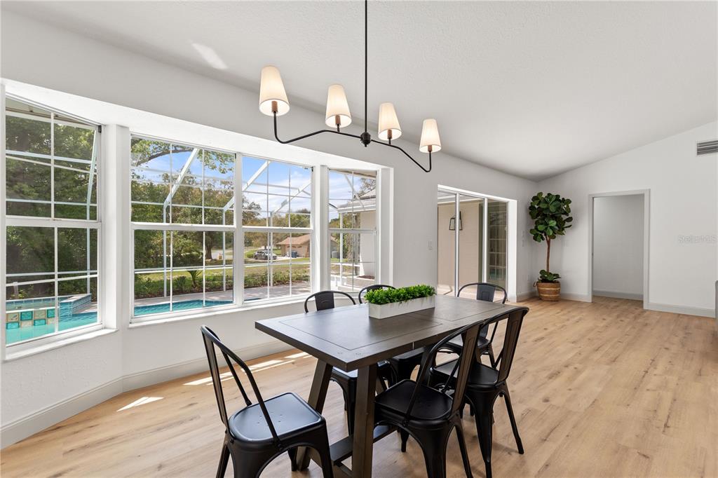 419 Silas Court Spring Hill, FL 34609 - Photo 20 of 56 a view of a dining room with furniture window and wooden floor