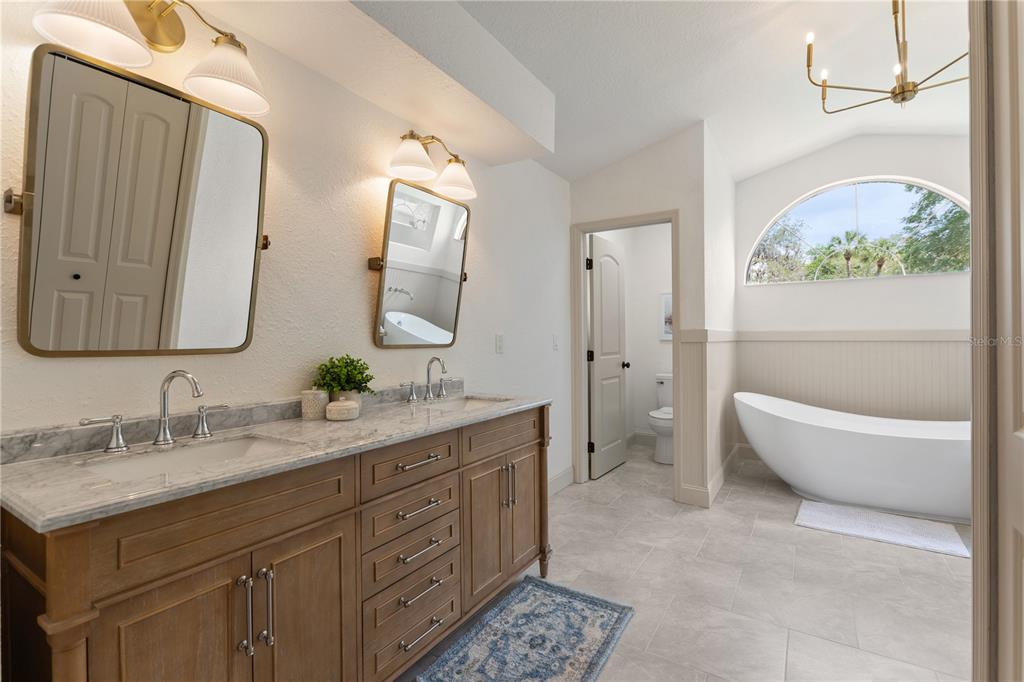 419 Silas Court Spring Hill, FL 34609 - Photo 28 of 56 a spacious bathroom with a double vanity sink mirror and bathtub