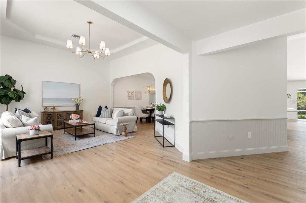 419 Silas Court Spring Hill, FL 34609 - Photo 5 of 56 a living room with furniture and a chandelier