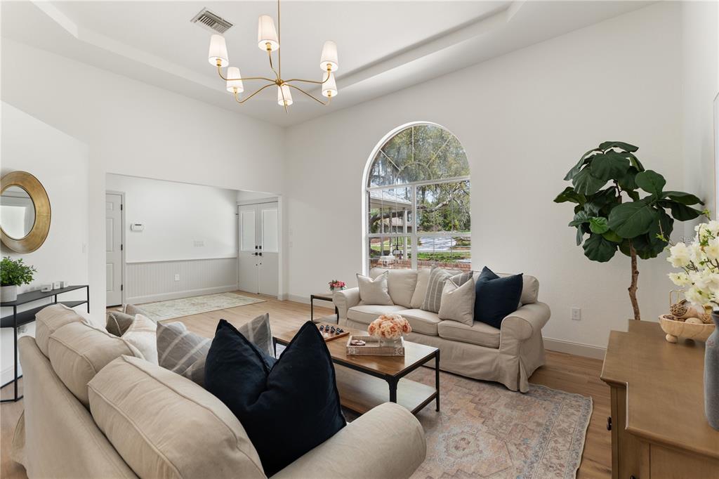 419 Silas Court Spring Hill, FL 34609 - Photo 8 of 56 a living room with furniture a chandelier and a window