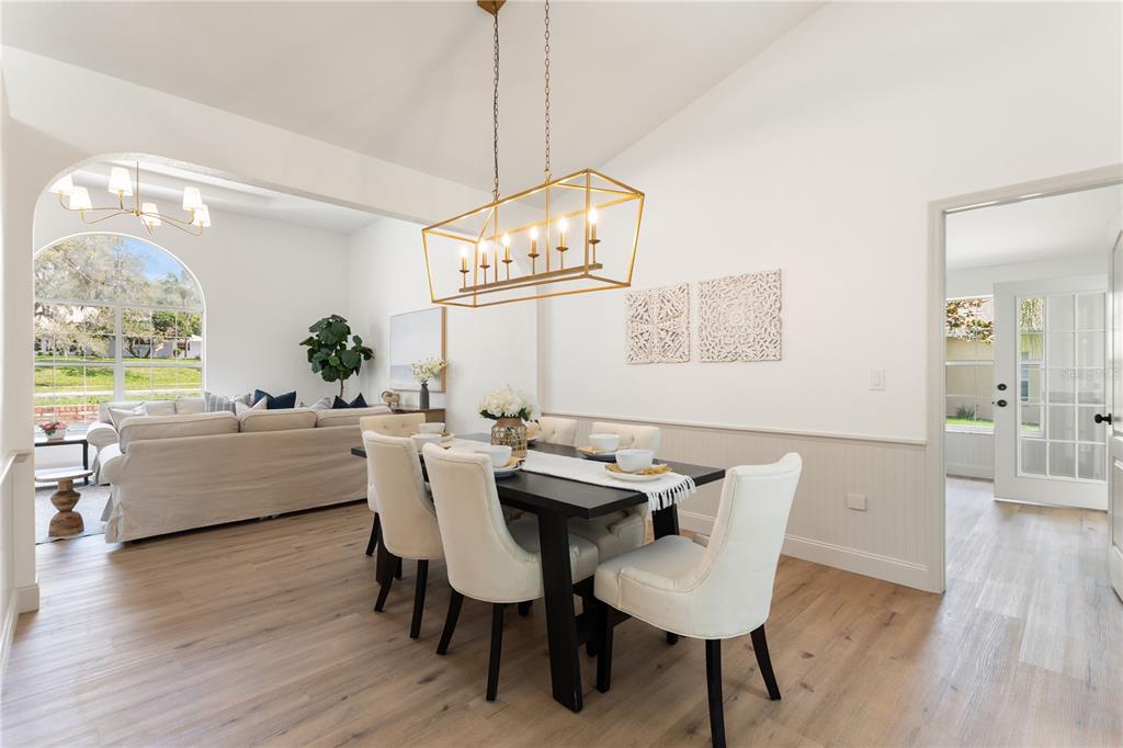 419 Silas Court Spring Hill, FL 34609 - Photo 9 of 56 a view of a dining room with furniture wooden floor and chandelier