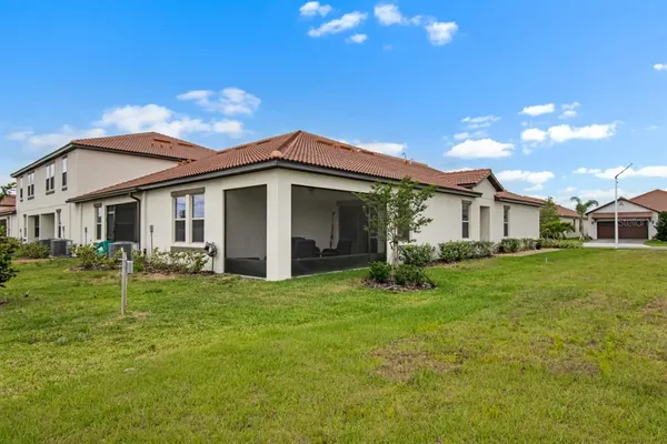 a front view of a house with a garden and plants