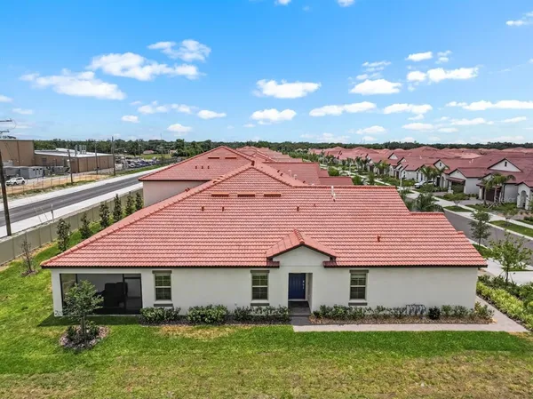 an aerial view of residential houses with outdoor space
