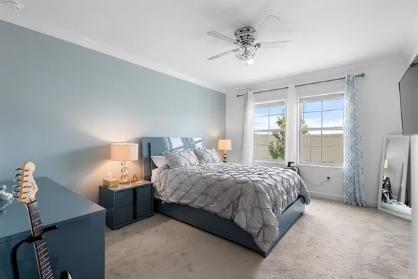 a bedroom with a bed and a chandelier