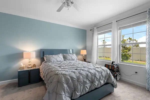 a bedroom with a bed lamp and window