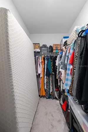 a view of walk in closet with clothes