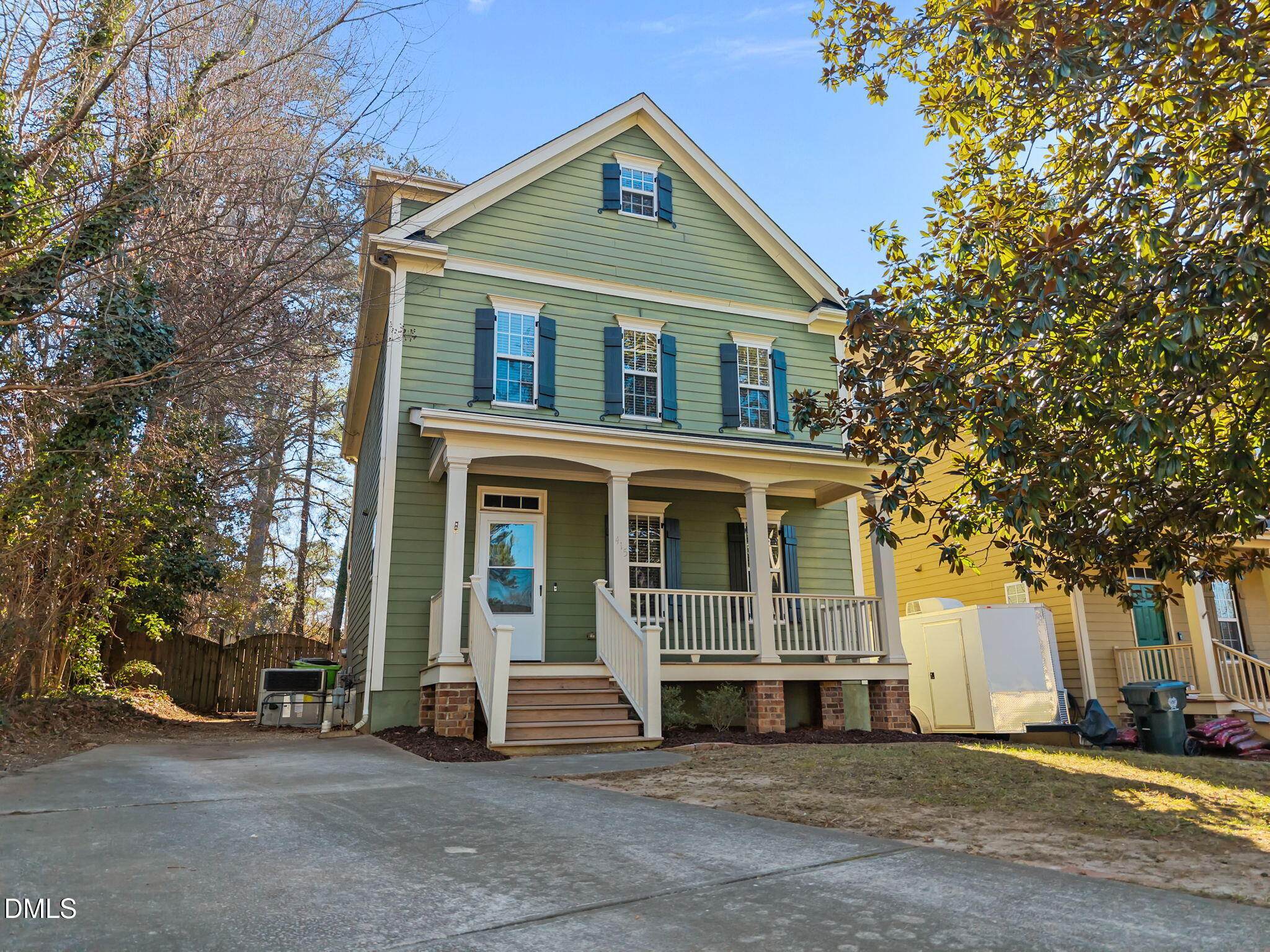415 Carolina Avenue Raleigh, NC 27606 - Photo 10 of 58 a view of a white house with large windows and a large tree