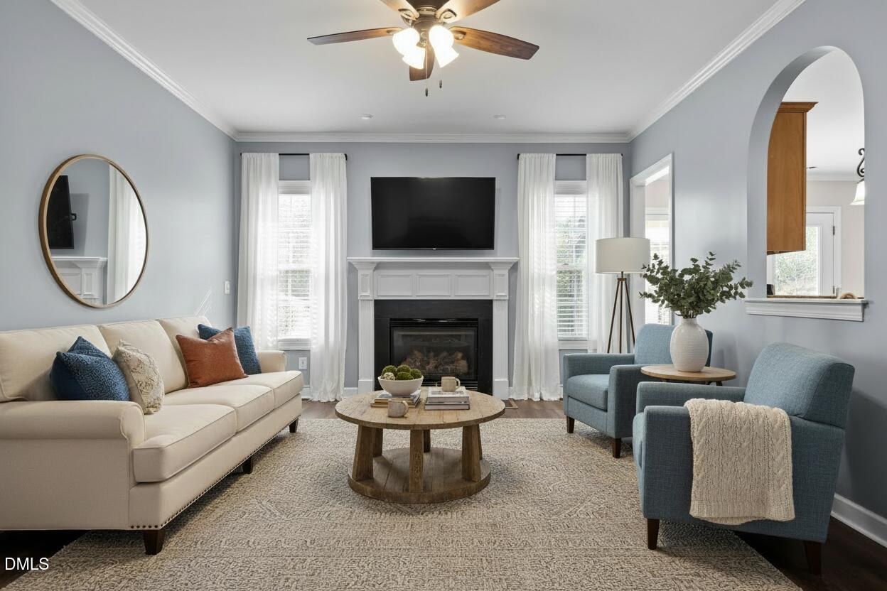415 Carolina Avenue Raleigh, NC 27606 - Photo 2 of 58 a living room with furniture a fireplace and a flat screen tv