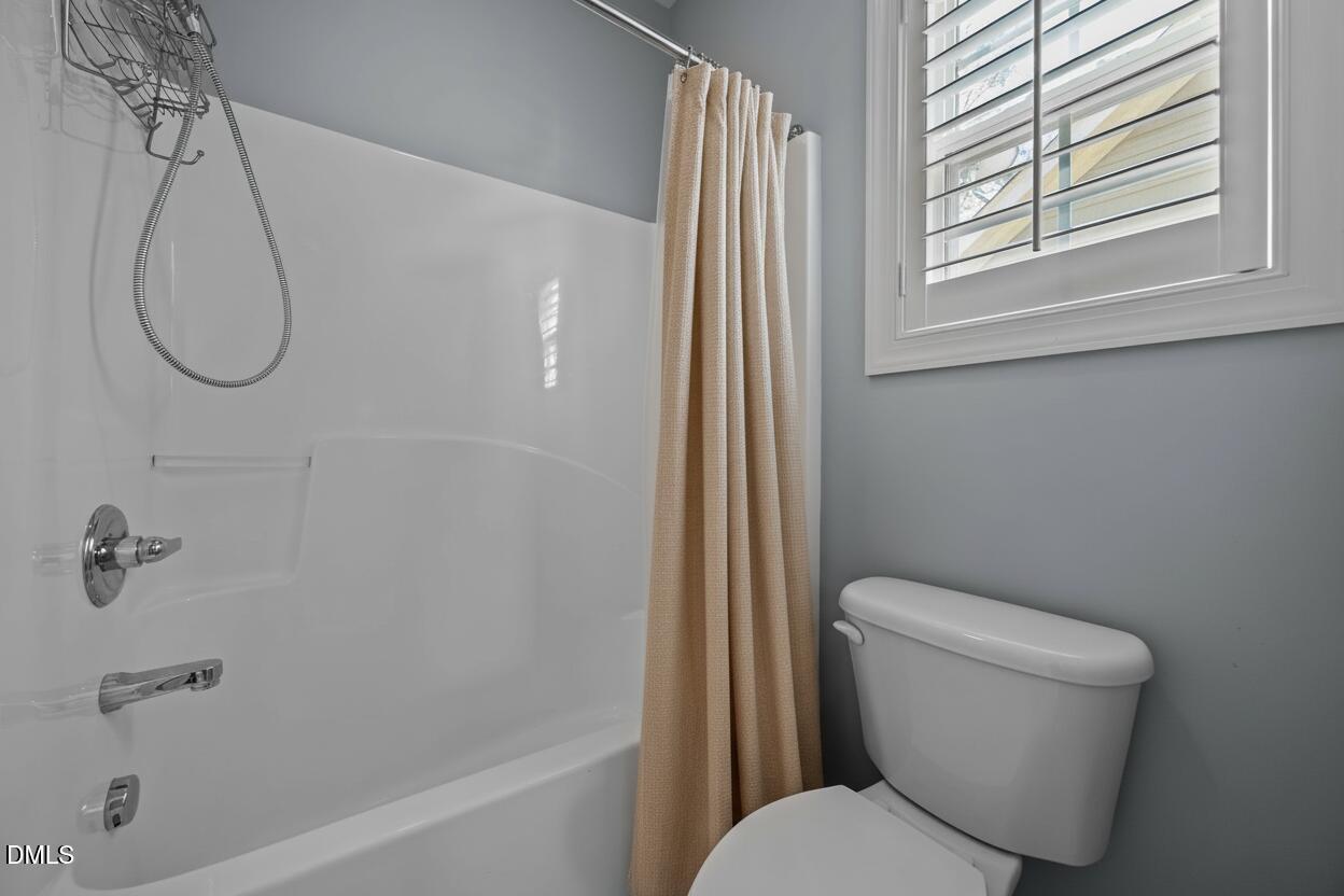 415 Carolina Avenue Raleigh, NC 27606 - Photo 37 of 58 a bathroom with a toilet and a shower