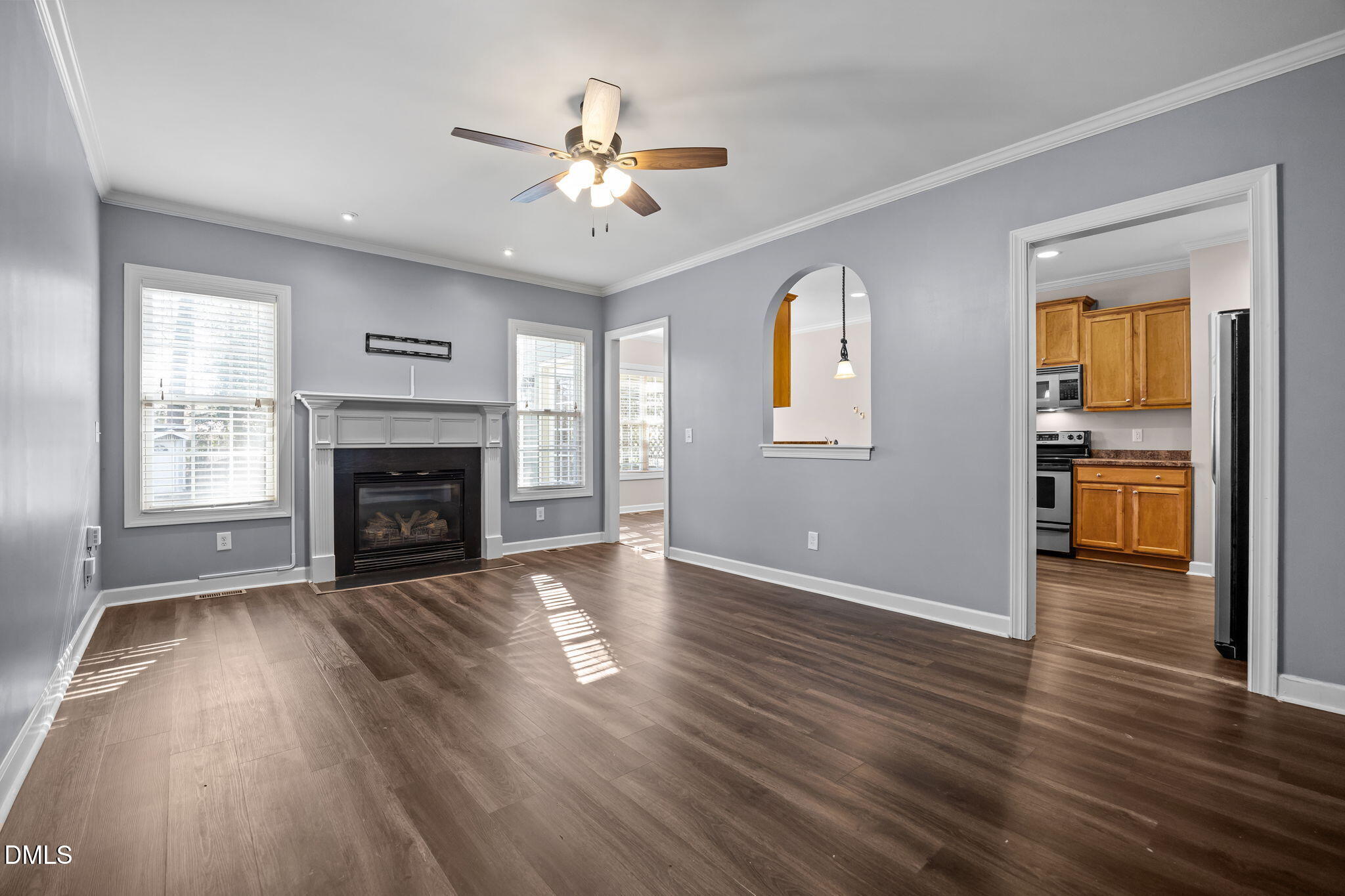 415 Carolina Avenue Raleigh, NC 27606 - Photo 47 of 58 an empty room with wooden floor fireplace and windows