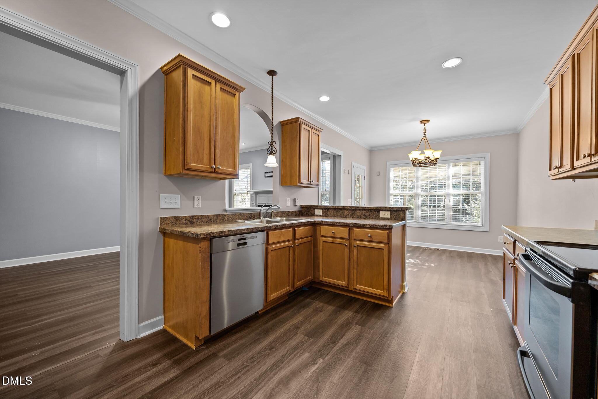 415 Carolina Avenue Raleigh, NC 27606 - Photo 49 of 58 a kitchen with granite countertop wooden floors a stove and a sink