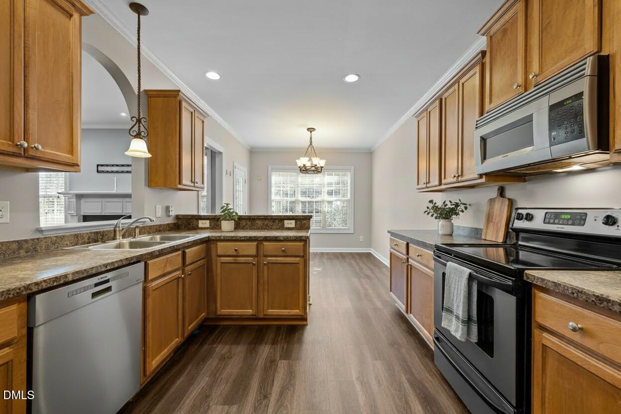 415 Carolina Avenue Raleigh, NC 27606 - Photo 4 of 58 a kitchen with stainless steel appliances granite countertop a stove a sink and a refrigerator