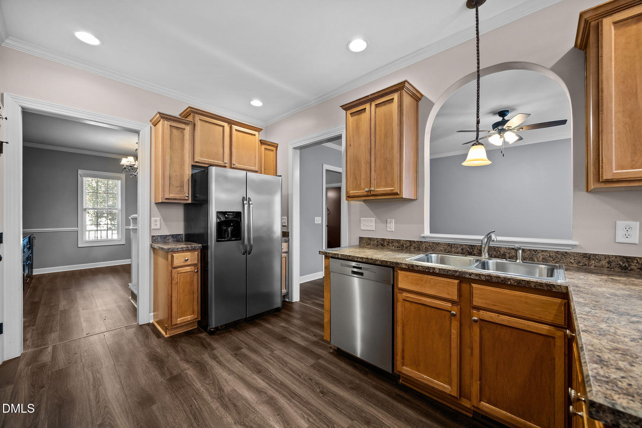 415 Carolina Avenue Raleigh, NC 27606 - Photo 50 of 58 a kitchen with stainless steel appliances granite countertop a refrigerator a sink dishwasher a stove and white countertops with wooden floor