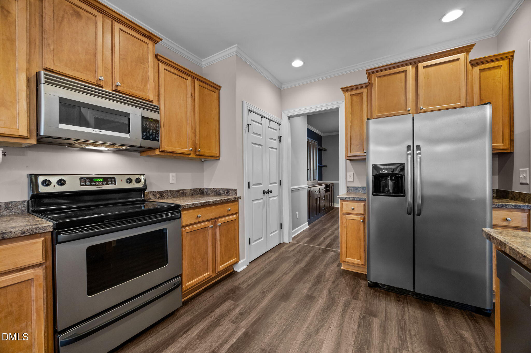 415 Carolina Avenue Raleigh, NC 27606 - Photo 51 of 58 a kitchen with stainless steel appliances granite countertop a stove a refrigerator and a microwave
