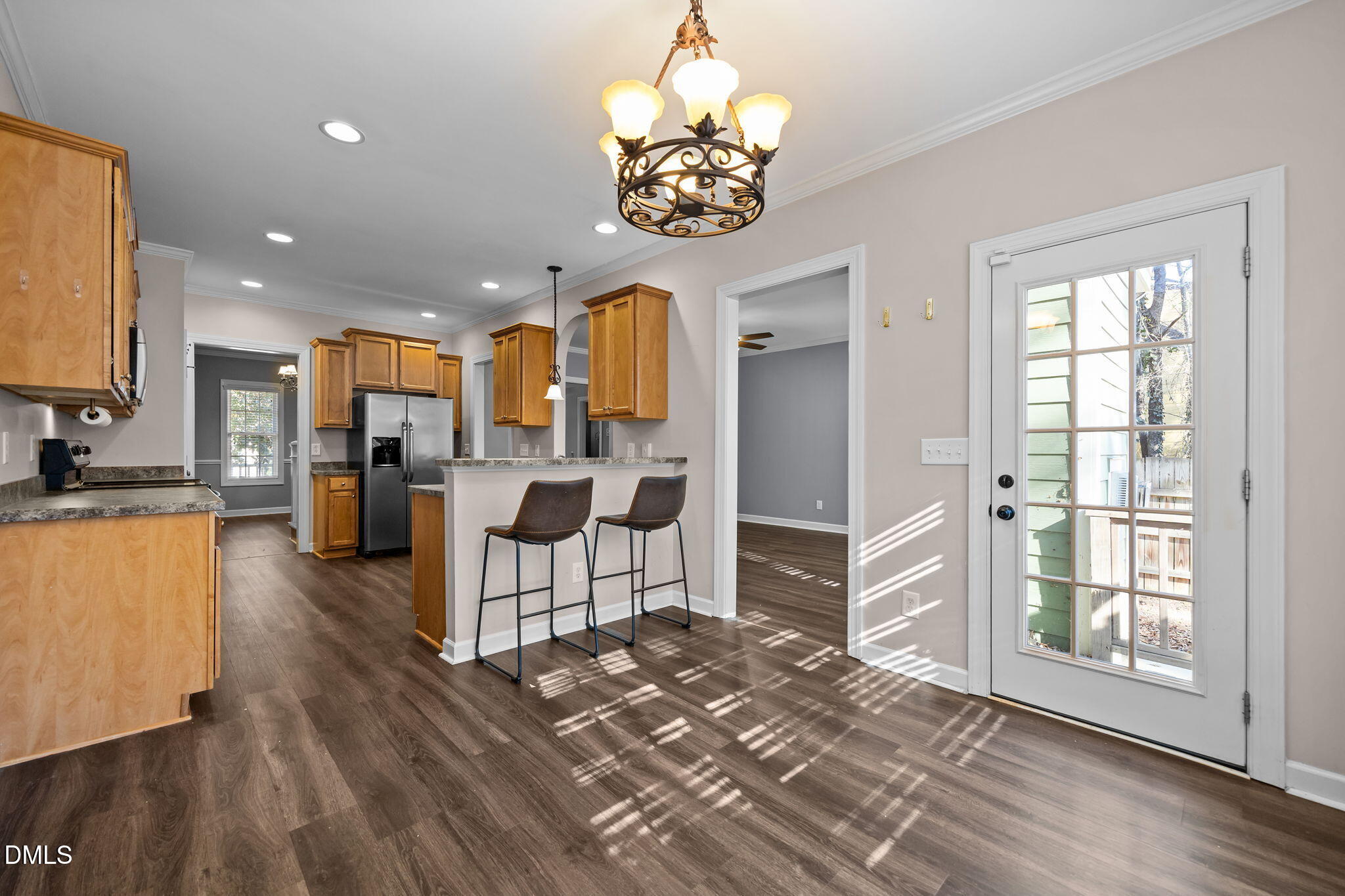 415 Carolina Avenue Raleigh, NC 27606 - Photo 53 of 58 a living room with stainless steel appliances furniture a chandelier and a view of kitchen