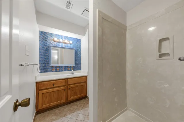 a bathroom with a double vanity sink and mirror
