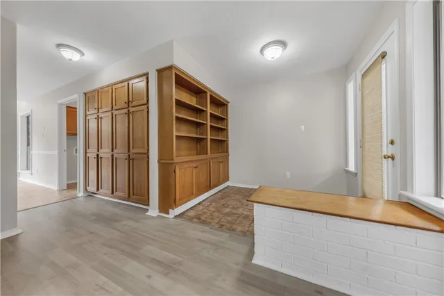 a view of empty room with wooden floor and cabinet