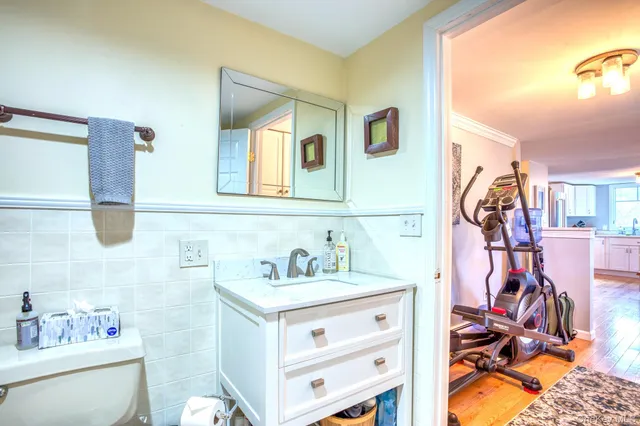 a bathroom with a sink vanity and a mirror