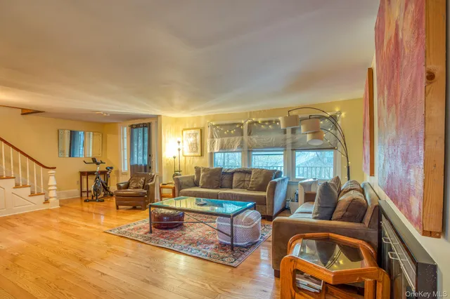 a living room with furniture and a floor to ceiling window