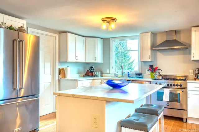 a kitchen with sink refrigerator and window