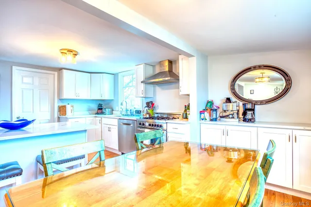 a kitchen with a sink a stove and a dining table with painted walls