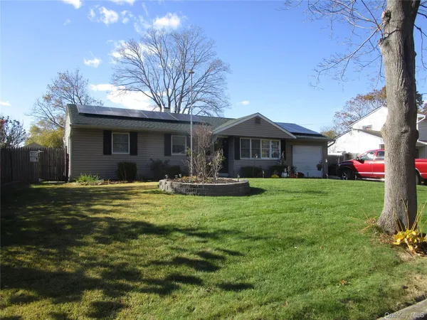 a front view of house with yard and green space