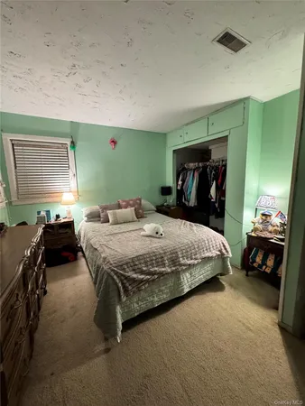 a bedroom with a bed and a car